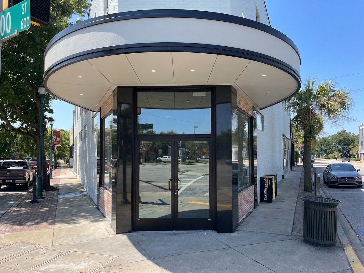 Curved glass storefront set over a stone base