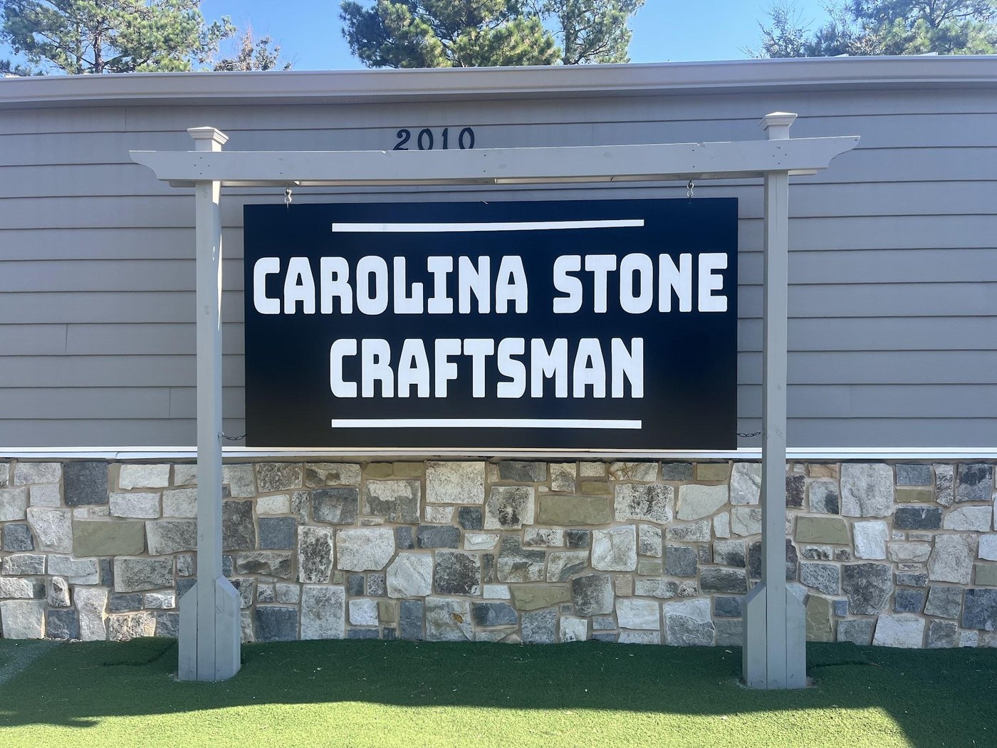 The Carolina Stone Craftsman road sign mounted on its stone base