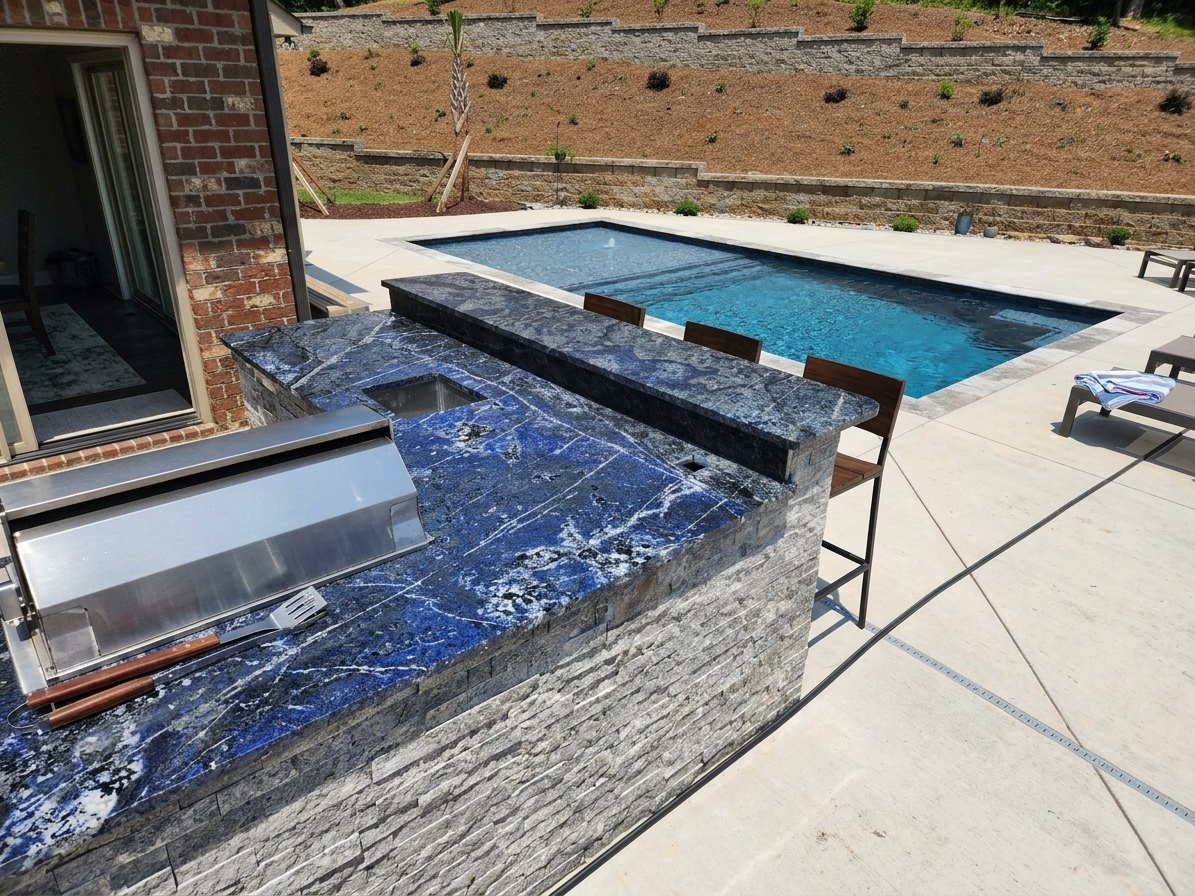 Blue granite coping wrapping a spa and the edge of a pool deck